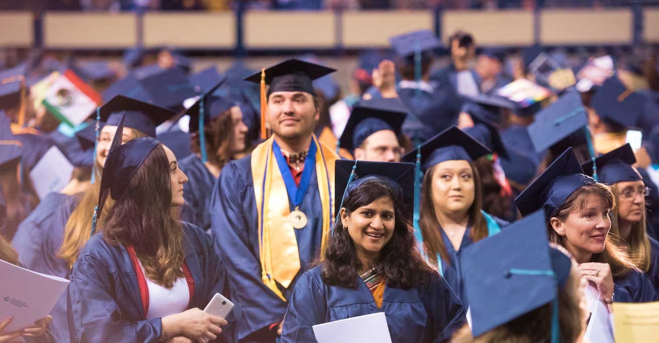 happy graduates in cap and gown